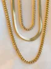 Load image into Gallery viewer, Sanza Jewelry three layered necklace set. The first necklace at 16 inches in length is the tennis cubic zirconia  14 karat gold filled necklace, second is the herringbone necklace sitting at 18 inches in length also 14 karat gold filled, lastly is the longest of the three the cuban link chain  20 inches long also 14 karat gold filled
